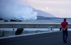 Smoke rises from the Cumbre Vieja volcano during an eruption, in La Palma island, Canary Islands, Spain. Lava tumbled over a cliff and into the Atlantic Ocean, setting off huge plumes of steam and possibly toxic gases that forced local residents outside the evacuation zone to remain indoors on Wednesday. The Cumbre Vieja volcano erupted on 19 September. Location: Spain. Author: Alejandro Martinez Velez/Sputnik. Spain Volcano Eruption
