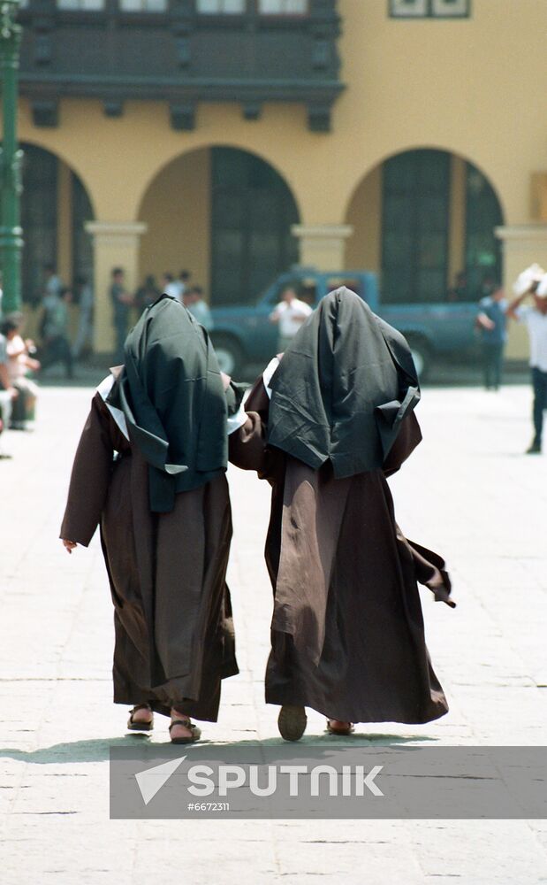 Catholic order nuns on central square in Lima