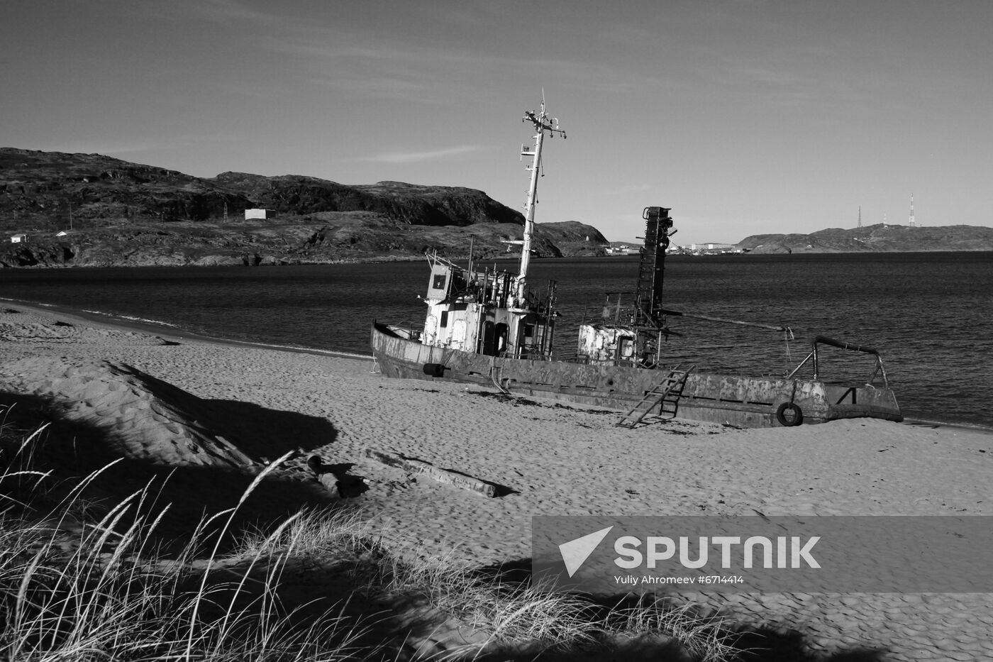 Rusty trawler on sandy beach in Teriberka