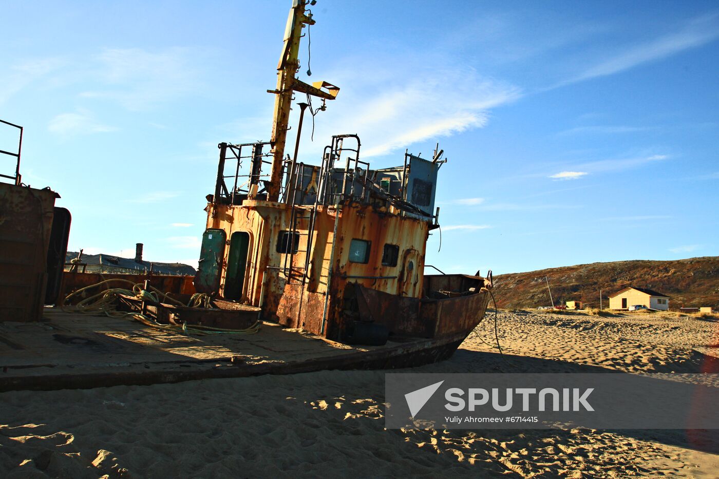 Rusty trawler on sandy beach in Teriberka