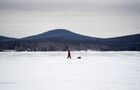 A man walks on the ice-covered Lake Tavatui, in Sverdlovsk region, Russia. Location: Russia, Sverdlovsk Oblast Region. Author: Pavel Lisitsyn. Russia Winter Fishing