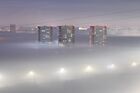 Multi-storey residential buildings are seen drowning in thick fog in Omsk, Russia. Location: Russia, Omsk. Author: Alexey Malgavko. Russia Weather