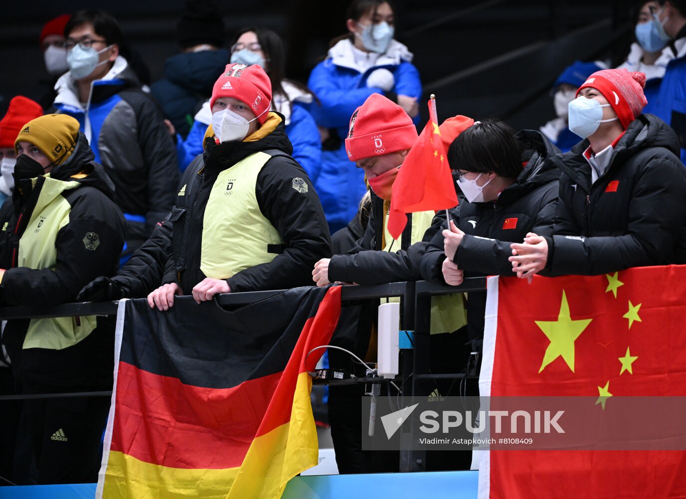Supporters of teams of Germany and China watch the women's singles luge event during the Beijing 2022 Winter Olympic Games at the National Sliding Centre in Yanqing, China. Location: China, Yanqing. Author: Vladimir Astapkovich/Sputnik. China Olympics 2022 Luge Women