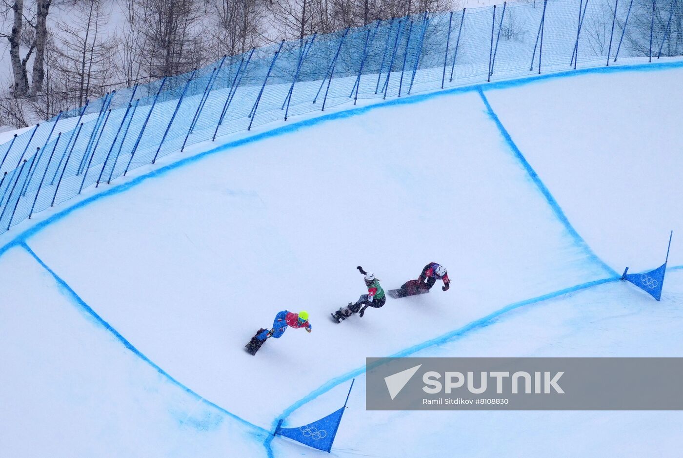 From left, Italy's Michela Moioli, Meghan Tierney, of the United States, and Switzerland's Lara Casanova compete in the women's snowboard cross 1/8 finals during the Beijing 2022 Winter Olympic Games at Genting Snow Park H & S Stadium in Zhangjiakou, China. Location: China, Zhangjiakou. Author: Ramil Sitdikov/Sputnik. China Olympics 2022 Snowboard Women