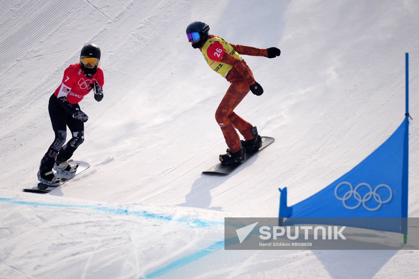 Faye Gulini, of the United States, and Canada's Tess Critchlow compete in the women's snowboard cross 1/8 finals during the Beijing 2022 Winter Olympic Games at Genting Snow Park H & S Stadium in Zhangjiakou, China. Location: China, Zhangjiakou. Author: Ramil Sitdikov/Sputnik. China Olympics 2022 Snowboard Women
