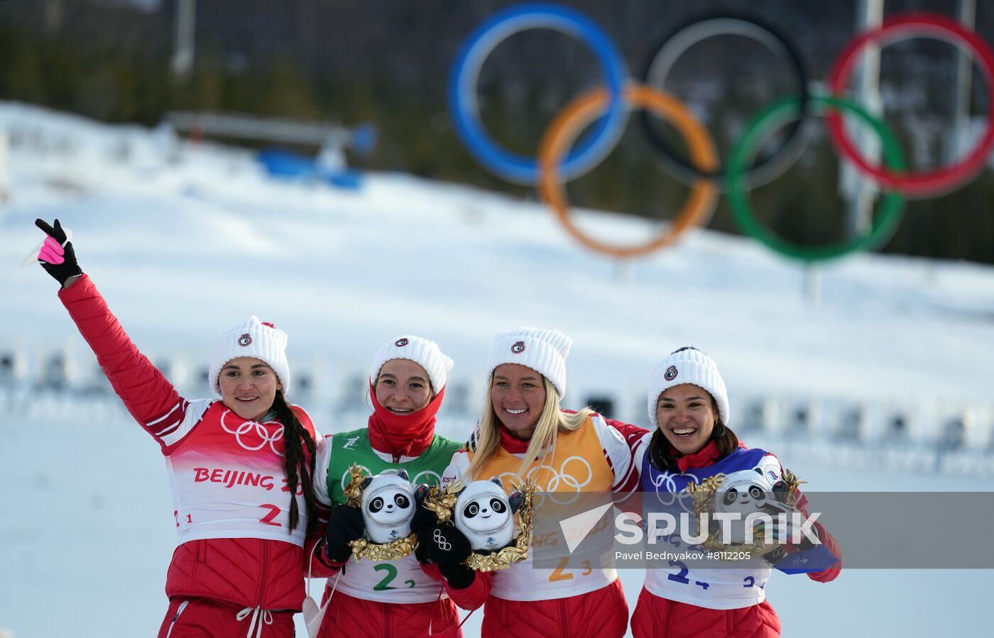 Gold medalists Russian Olympic Committee's Yulia Stupak, Natalia Nepryaeva, Tatiana Sorina and Veronika Stepanova celebrate during a flower ceremony for the women's cross-country 4x5 km relay event during the Beijing 2022 Winter Olympic Games at the National Cross-Country Skiing Centre in Zhangjiakou, China. Location: China, Zhangjiakou. Author: Pavel Bednyakov/Sputnik. China Olympics 2022 Cross-Country Skiing Women