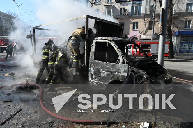 Firefighters extinguish a burning car after a recent shelling in Donetsk, Donetsk People's Republic. The Donetsk authorities reported a Ukrainian Tochka-U missile had been shot down near the Government House in the city center, according to preliminary data, 20 people died and nine were injured. Location: Donetsk People's Republic, Donetsk. Author: Maksim Blinov/Sputnik. DPR Shelling Aftermath