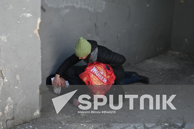 A woman helps an injured man after a recent shelling in Donetsk, Donetsk People's Republic. The Donetsk authorities reported a Ukrainian Tochka-U missile had been shot down near the Government House in the city center, according to preliminary data, 20 people died and nine were injured. Location: Donetsk People's Republic, Donetsk. Author: Maksim Blinov/Sputnik. DPR Shelling Aftermath
