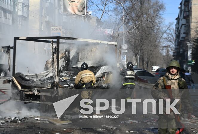 Firefighters extinguish a burning car after a recent shelling in Donetsk, Donetsk People's Republic. The Donetsk authorities reported a Ukrainian Tochka-U missile had been shot down near the Government House in the city center, according to preliminary data, 20 people died and nine were injured. Location: Donetsk People's Republic, Donetsk. Author: Maksim Blinov/Sputnik. DPR Shelling Aftermath