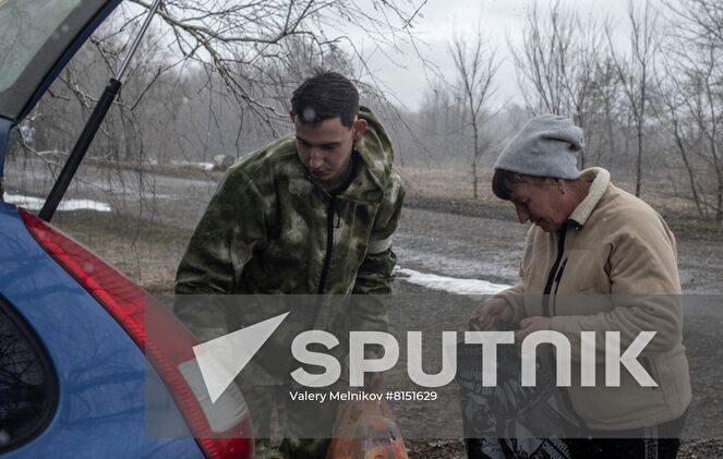 Luhansk resident Yuri Gluschenko and his mother Olga are seen outside a house, in the village of Ganusovka, the Luhansk People's Republic. After the liberation of the village and that came under control of the Lugansk People's Republic, Yuri was able to meet with his mother, whom he had not seen for eight years. Location: Luhansk People's Republic. Author: Valery Melnikov/Sputnik. LPR Family Reunion