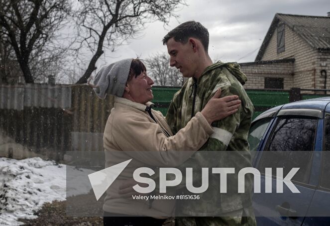 Luhansk resident Yuri Gluschenko and his mother Olga are seen outside a house, in the village of Ganusovka, the Luhansk People's Republic. After the liberation of the village and that came under control of the Lugansk People's Republic, Yuri was able to meet with his mother, whom he had not seen for eight years. Location: Luhansk People's Republic. Author: Valery Melnikov/Sputnik. LPR Family Reunion
