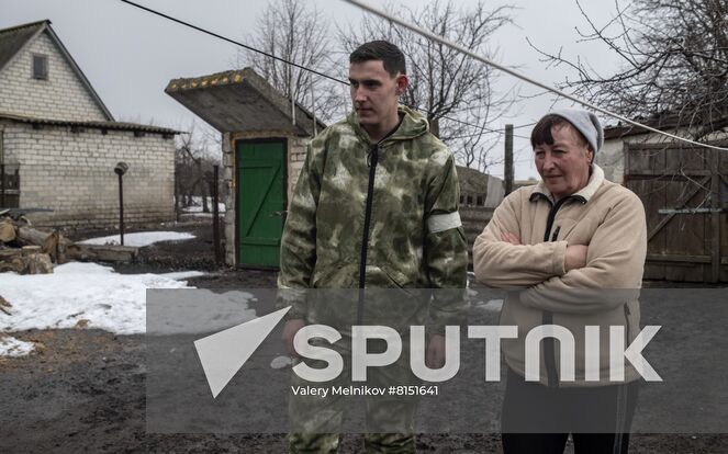 Luhansk resident Yuri Gluschenko and his mother Olga are seen outside a house, in the village of Ganusovka, the Luhansk People's Republic. After the liberation of the village and that came under control of the Lugansk People's Republic, Yuri was able to meet with his mother, whom he had not seen for eight years. Location: Luhansk People's Republic. Author: Valery Melnikov/Sputnik. LPR Family Reunion