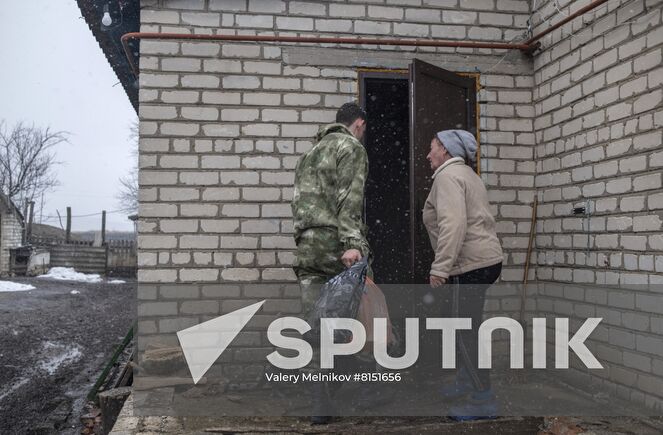 Luhansk resident Yuri Gluschenko and his mother Olga are seen outside a house, in the village of Ganusovka, the Luhansk People's Republic. After the liberation of the village and that came under control of the Lugansk People's Republic, Yuri was able to meet with his mother, whom he had not seen for eight years. Location: Luhansk People's Republic. Author: Valery Melnikov/Sputnik. LPR Family Reunion