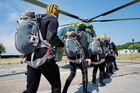 Servicemen of the Baltic Fleet intelligence unit are loaded into a helicopter before performing training jumps from a helicopter in the waters of the Baltic Sea, during marine drills, in Russia. Taking into account the specifics of the units, military personnel land in marine areas in wetsuits, diving equipment and a special parachute system. Location: Baltiysk. Author: Mikhail Golenkov/Sputnik. Russia Navy Baltic Fleet Drills
