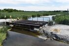 Workers reconstruct a bridge over the Krynka River on the Donetsk-Luhansk highway near the village of Nizhnyaya Krynka, in the Donetsk People's Republic. Location: Donetsk People's Republic. Author: Sergey Baturin/Sputnik. DPR Russia Ukraine Military Operation Bridge Reconstruction