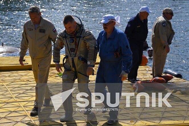 Russian cosmonaut Alexey Ovchinin, in center, crew member of the 70th expedition to the International Space Station, is seen after finishing practice an emergency landing in water at Russia's Emergency Ministry base in Noginsk, Moscow region, Russia. Location: Russia, Moscow region. Author: Evgeny Odinokov/Sputnik. Russia Space