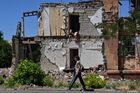 A woman walks past a residential building destroyed by shelling in the course of Russia's military operation in Ukraine, is seen in Mariupol, Donetsk People's Republic. Location: Donetsk People's Republic, Mariupol. Author: RIA Novosti/Sputnik. DPR Russia Ukraine Military Operation
