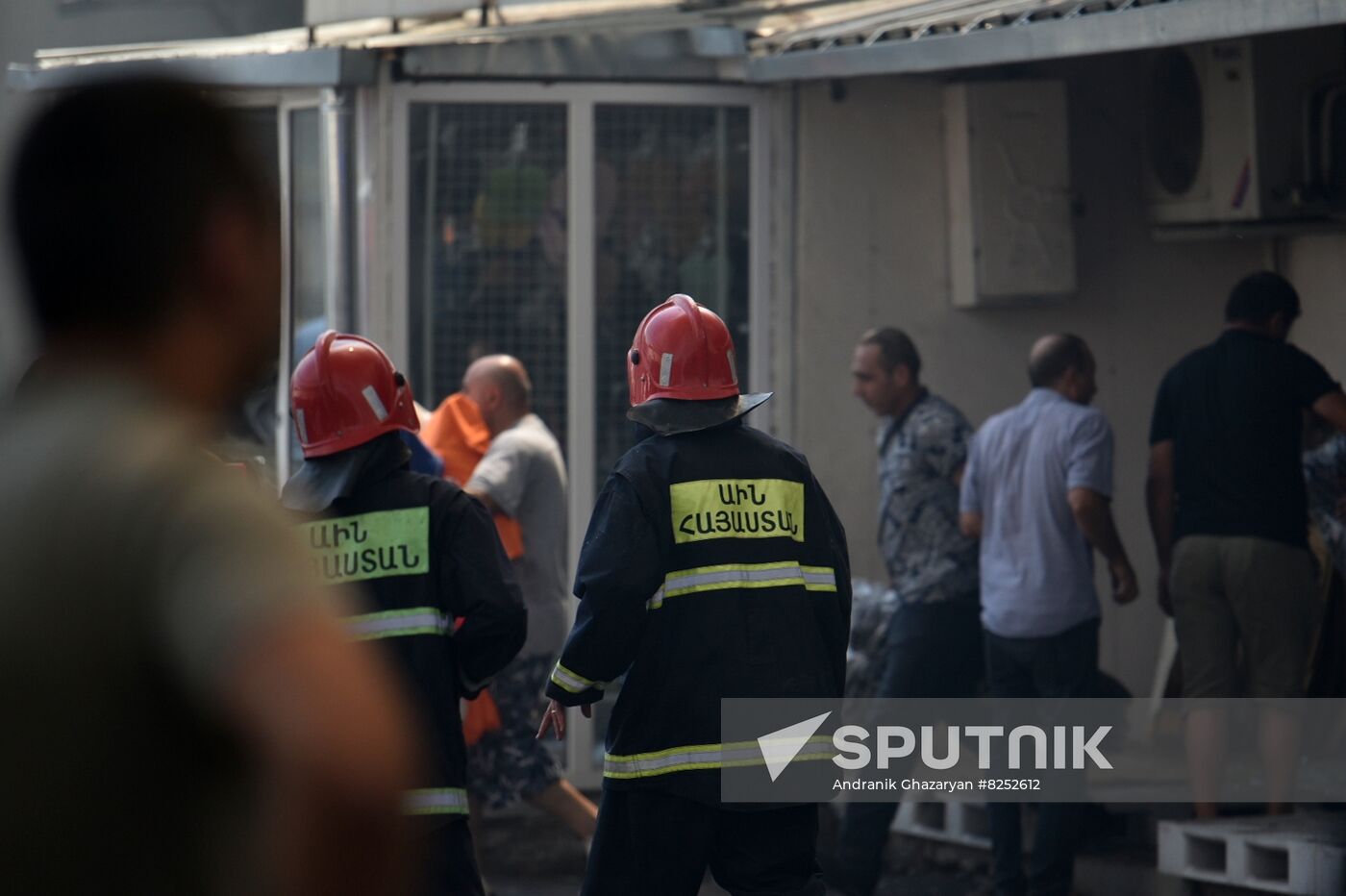 Firefighters walk near the site of an explosion near the Surmalu shopping center, which specializes in the wholesale of various goods and products, in Yerevan, Armenia. Location: Armenia, Yerevan. Author: Andranik Ghazaryan/Sputnik/РИА Новости. Armenia Retail Market Explosion