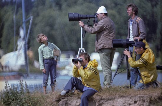 Photojournalists and cameramen film windsurfing competition