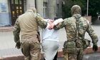 In this handout video grab released by the Russian Federal Security Service (FSB), FSB officers detain a member of Katiba al-Tawhid wal-Jihad terrorist organization (banned in Russia), in Russia. Members of the terrorist cell sponsored terrorists in Syria and called for terrorist actions in Russia. Eight members were detained in Karsnoyarsk, Moscow and Novosibirsk. Editorial use only, no archive, no commercial use. Location: Russia. Russia Terrorists Detention