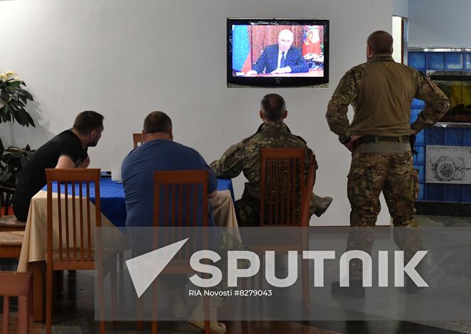 Servicemen watch a television showing Russian President Vladimir Putin addressing the nation, in Donetsk People's Republic. Putin on September 21 announced a partial mobilization for Russian citizens a day after Luhansk and Donetsk People's Republics, and Russian-controlled Zaporizhzhia and Kherson regions in southern Ukraine announced plans to hold votes on becoming integral parts of Russia. Location: Donetsk People's Republic. Author: RIA Novosti/Sputnik. Russia Putin Address Broadcast
