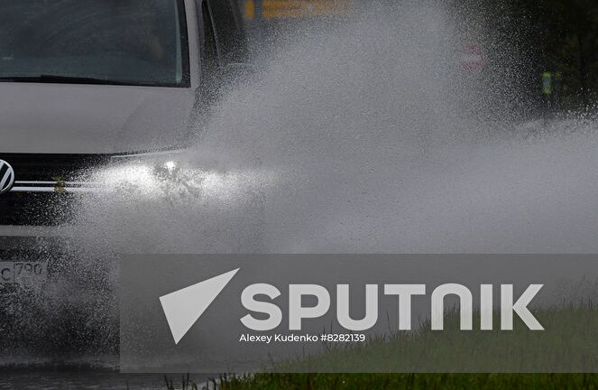 A cars passes through puddles during heavy rain in Moscow, Russia. Location: Russia, Moscow. Author: Alexey Kudenko/Sputnik. Russia Weather