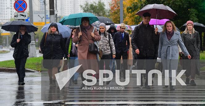 Pedestrians holding umbrellas cross a street during heavy rain in Moscow, Russia. Location: Russia, Moscow. Author: Alexey Kudenko/Sputnik. Russia Weather