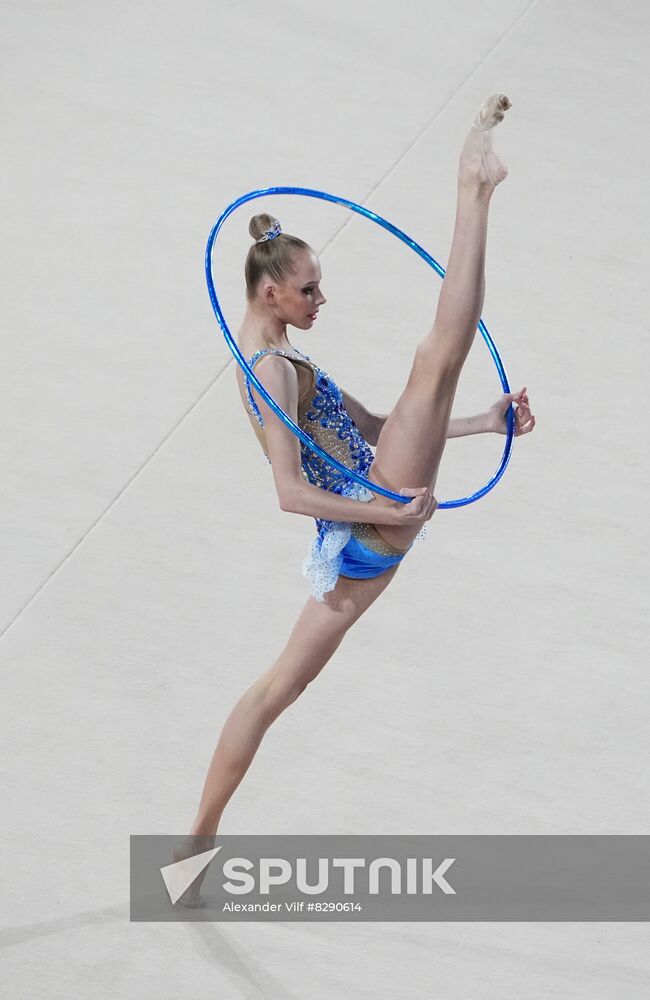 Girl doing rhythmic gymnastics with blue ball