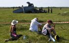 Young women sit on the grass near the site, where the twin-engine L-410 plane crashed near the Tanay aerodrome, which provides parachuting services, leaving four people dead, in Kemerovo region, Russia. Five survivors of the plane crash are in intensive care units with critical injuries, while the condition of eight others is assessed as stable. It was a training flight with 17 skydivers and two experienced crew members. Location: Russia, Kemerovo region. Author: Alexandr Kryazhev. Russia Plane Crash