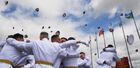 Cadets of the Ussuriysk branch of the Suvorov Military School throw their caps in the air as they celebrate during the graduation ceremony in the Primorskiy Krai region, Russia. The Suvorov Military School is a famous Russian boarding school, which prepares teenagers for service as officers in the Russian Army. Location: Russia, Primorsky krai region, Ussuriysk. Author: Vitaliy Ankov. Russia Cadets Graduation