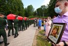 Servicemen carry coffins during the ceremony of the reburial of the remains of 134 Soviet Red Army soldiers who were killed in the battle of Mozhaisk during WWII, in the Mokroye village, Moscow region, Russia. Location: Russia, Moscow region. Author: Vladimir Vyatkin. Russia WWII Soviet Soldiers Reburial