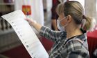 A woman holds her ballot at a polling station during parliamentary elections, in Krasnodar, Russia. Russia holds legislative elections on 17-19 September 2021. Voters will elect members of the Russian State Duma and heads of nine Russian regions and 39 constituent regions. Location: Russia, Krasnodar. Author: Vitaly Timkiv/Sputnik. Russia Parliamentary Elections
