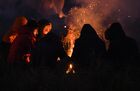 Refugees warm up around a fire at a migrant camp on the Belarusian-Polish border in Grodno region, Belarus. Migrants from the Middle East and North Africa trapped in Belarus have converged on the border with Poland, where razor wire fences and Polish troops have repeatedly blocked their entry. Location: Belarus, Grodno Region. Author: Viktor Tolochko/Sputnik/РИА Новости. Belarus Poland Border Refugees
