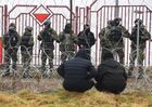 Polish servicemen guard the Bruzgi-Kuznica Bialostocka border crossing near the Belarusian-Polish border as refugees stand near barbed wire fence, in Grodno region, Belarus. Migrants from the Middle East and North Africa trapped in Belarus have converged on the border with Poland, where razor wire fences and Polish troops have repeatedly blocked their entry. Location: Belarus, Grodno Region. Author: Viktor Tolochko/Sputnik/РИА Новости. Belarus Poland Border Refugees