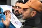 Refugees hold placards at the Bruzgi logistics centre providing accommodation to migrants near the Bruzgi-Kuznica Bialostocka border crossing at the Belarusian-Polish border in Grodno region, Belarus. Migrants from the Middle East and North Africa trapped in Belarus have converged on the border with Poland, where razor wire fences and Polish troops have repeatedly blocked their entry. Location: Belarus, Grodno Region. Author: Pavel Bednyakov/Sputnik. Belarus Poland Border Refugees