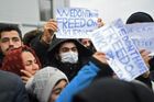 Refugees hold placards at the Bruzgi logistics centre providing accommodation to migrants near the Bruzgi-Kuznica Bialostocka border crossing at the Belarusian-Polish border in Grodno region, Belarus. Migrants from the Middle East and North Africa trapped in Belarus have converged on the border with Poland, where razor wire fences and Polish troops have repeatedly blocked their entry. Location: Belarus, Grodno Region. Author: Pavel Bednyakov/Sputnik. Belarus Poland Border Refugees