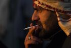 A refugee man smokes a cigarette at the Bruzgi logistics centre providing accommodation to migrants near the Bruzgi-Kuznica Bialostocka border crossing at the Belarusian-Polish border in Grodno region, Belarus. Migrants from the Middle East and North Africa trapped in Belarus have converged on the border with Poland, where razor wire fences and Polish troops have repeatedly blocked their entry. Location: Belarus, Grodno Region. Author: Pavel Bednyakov/Sputnik. Belarus Poland Border Refugees