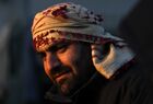 A refugee is seen at the Bruzgi logistics centre providing accommodation to migrants near the Bruzgi-Kuznica Bialostocka border crossing at the Belarusian-Polish border in Grodno region, Belarus. Migrants from the Middle East and North Africa trapped in Belarus have converged on the border with Poland, where razor wire fences and Polish troops have repeatedly blocked their entry. Location: Belarus, Grodno Region. Author: Pavel Bednyakov/Sputnik. Belarus Poland Border Refugees