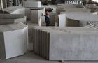 A worker cleans the plates from foreign inclusions in the workshop for the production of slabs and overlaps at the plant of reinforced concrete structures in the village of Vasyurinskoye, Krasnodar region, Russia. Location: Krasnodar region. Author: Vitaly Timkiv/Sputnik. Russia Construction Materials Industry