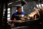 An employee works at a lathe in a machine shop at the Nizhneturinsky Machine-Building Plant, a separate division of the Ural-Siberian Industrial Company, in the city of Nizhnyaya Tura, Sverdlovsk region, Russia. The Company manufactures high-tech drilling rigs for operational and exploratory drilling. Location: Sverdlovsk Oblast Region. Author: Pavel Lisitsyn/Sputnik. Russia Mechanical Engineering Industry