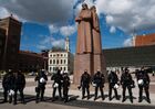 Riot police officers stand guard during a rally against the decision of the Riga City Council to demolish the Monument to the Liberators of Soviet Latvia and Riga from the German Fascist Invaders in central Riga, Latvia. The Parliament of Latvia earlier adopted a law to suspend the operation of a clause of the intergovernmental agreement with Russia on the protection of monuments to Soviet soldiers in the country, which would allow the dismantling of the monument to the Liberators of Riga. Location: Latvia, Riga. Author: Sergey Melkonov/Sputnik. Latvia WWII Soviet Monument Demolition
