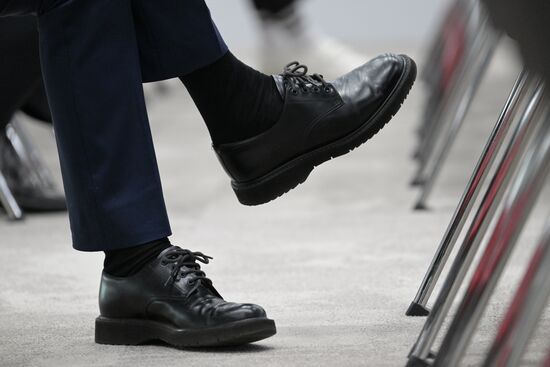 Shoes of a participant in the XIV International Economic Forum RUSSIA — ISLAMIC WORLD: KAZANFORUM 2023. Photos may be used as stated in the media bank section concerning the forum. Location: Russia, Republic of Tatarstan, Kazan. Author: Alexandr Kryazhev/ANO “Directorate for Sports and Social Projects”. KAZANFORUM 2023. Sidelines