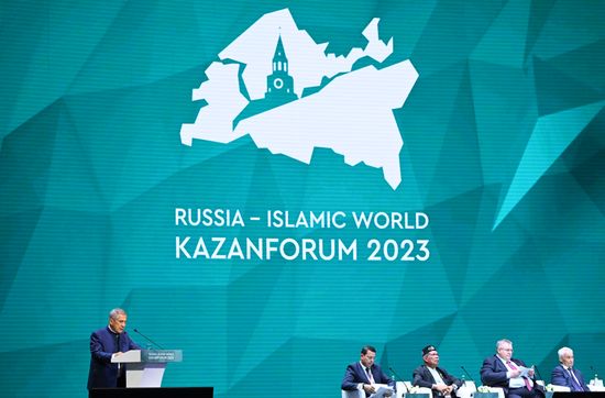 Left: Head of the Tatarstan Republic Rustam Minnikhanov is seen speaking at the plenary session of the Russia – Islamic World 14th International Economic Forum: Economy of Trust: Partnership between the Russian Federation and the OIC Countries. Photos may be used subject to the terms in the forum-specific section of the media bank. Location: Russia, Republic of Tatarstan, Kazan. Author: Maksim Bogodvid/ANO “Directorate for Sports and Social Projects”. KAZANFORUM 2023. Plenary session of the Russia – Islamic World 14th International Economic Forum