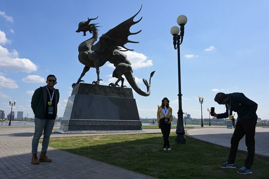 Guests of the forum taking photos near the sculpture of Dragon Zilant in the Kazan Kremlin State Historical, Architectural and Artistic Reserve Museum during a sightseeing tour of the city. Photos may be used as stated in the media bank section concerning the forum. Location: Russia, Republic of Tatarstan, Kazan. Author: Alexandr Kryazhev/ANO “Directorate for Sports and Social Projects”. KAZANFORUM 2023. Sightseeing tour of Kazan