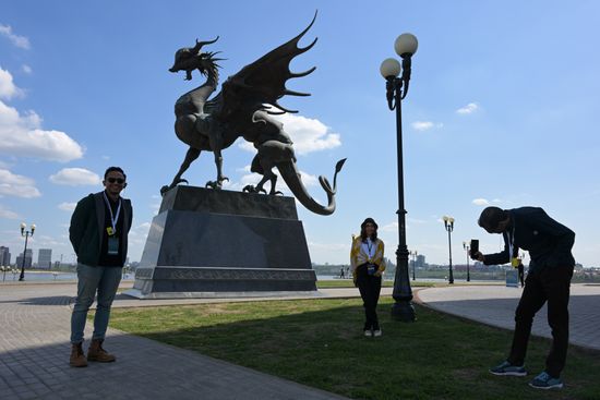 Guests of the forum taking photos near the sculpture of Dragon Zilant in the Kazan Kremlin State Historical, Architectural and Artistic Reserve Museum during a sightseeing tour of the city. Photos may be used as stated in the media bank section concerning the forum. Location: Russia, Republic of Tatarstan, Kazan. Author: Alexandr Kryazhev/ANO “Directorate for Sports and Social Projects”. KAZANFORUM 2023. Sightseeing tour of Kazan