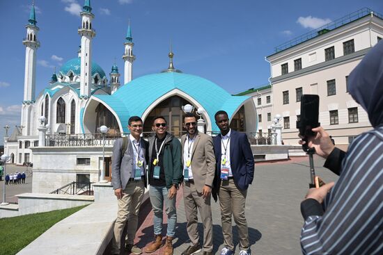 Guests of the forum taking photos near the Kazan Kremlin State Historical, Architectural and Artistic Reserve Museum during a sightseeing tour of the city. Photos may be used as stated in the media bank section concerning the forum. Location: Russia, Republic of Tatarstan, Kazan. Author: Alexandr Kryazhev/ANO “Directorate for Sports and Social Projects”. KAZANFORUM 2023. Sightseeing tour of Kazan