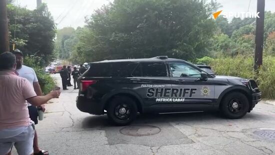 People gather at the Fulton County Jail to watch Donald Trump surrender