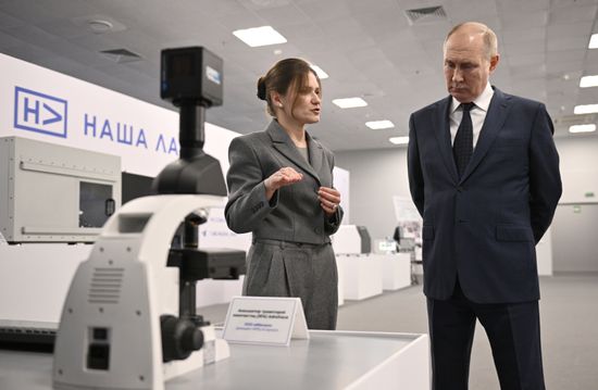 Russian President Vladimir Putin, accompanied by Moscow Institute of Physics and Technology (MIPT) senior researcher Elizaveta Mochalova, tours an exhibition as part of the 3rd Young Scientists Congress at the Sirius Park of Science and Art in Krasnodar region, Russia. Location: Russia, Federal territory 'Sirius'. Author: Kirill Zykov. Russia Putin Young Scientists Congress
