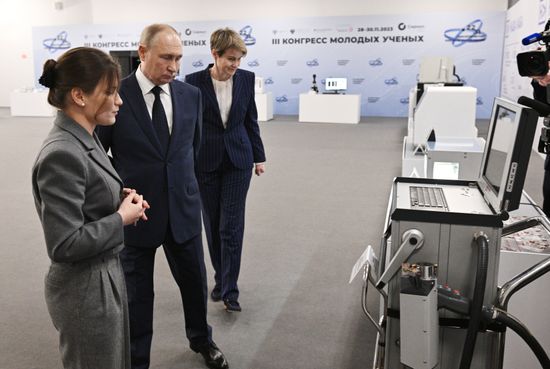 Russian President Vladimir Putin, accompanied by Sirius Federal Territory Chairman of the Board and Talent and Success Foundation head Elena Shmeleva and Moscow Institute of Physics and Technology (MIPT) senior researcher Elizaveta Mochalova, tours an exhibition as part of the 3rd Young Scientists Congress at the Sirius Park of Science and Art in Krasnodar region, Russia. Location: Russia, Federal territory 'Sirius'. Author: Kirill Zykov. Russia Putin Young Scientists Congress