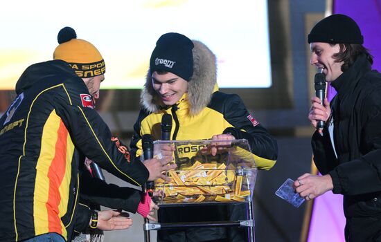 International RUSSIA EXPO forum and exhibition. Lada Granta Dream Car Lottery from Rosneft Co. and Lada Sport Rosneft Racing Team. Main outdoor stage. From left: Leonid Panfilov, driver, LADA Sport Rosneft racing team; Maxim Turiyev, driver, LADA Sport Rosneft racing team; Valentin Soroka (Val), radio host, Brigada U morning show. Location: Russia, Moscow. Author: Maksim Blinov/Sputnik. RUSSIA EXPO. Lada Granta Dream Car Lottery from Rosneft Co. and Lada Sport Rosneft Racing Team